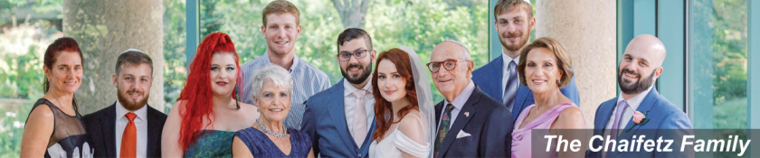 picture of 8 members of a family dressed nicely at a wedding