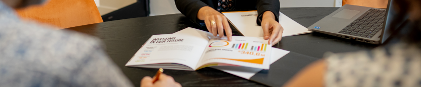 hand pointing to colorful graph on a table