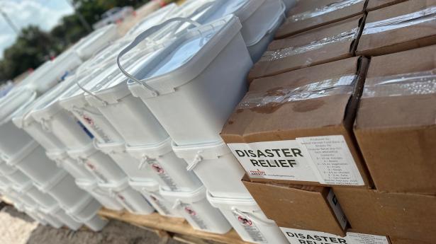 White and brown boxes stacked up, some say "Disaster Relief."