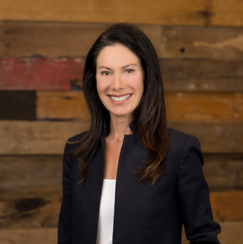 woman in black blazer with white shirt and dark hair