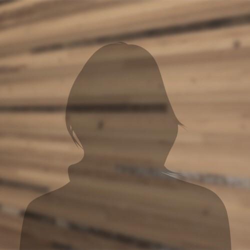 shadow of a woman outline against a wood background