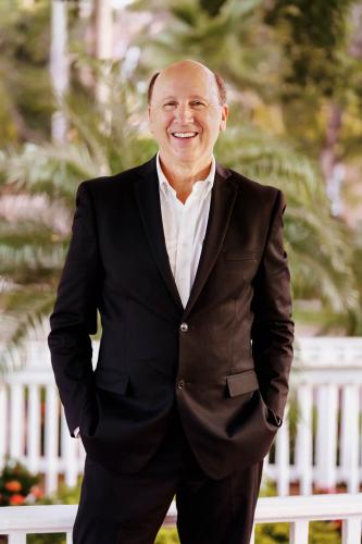 Gulf Coast President|CEO Mark Pritchett standing, smiling.