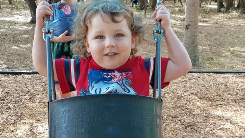 Child smiling in swing