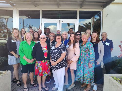 23 people smile outside of Gulf Coast Community Foundation's Venice Headquarters