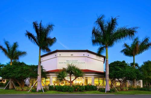 Outside of Gulf Coast Community Foundation's Venice Office. Building, palm trees, sky.