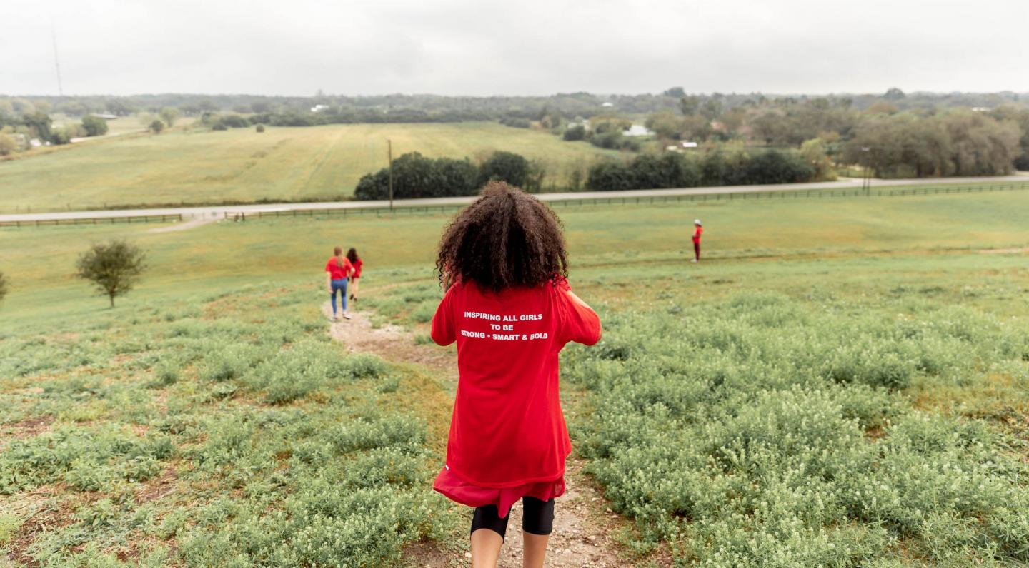 girls running down a hill