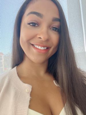 One woman with long dark hair smiles at camera.